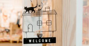 Interior design wooden door decoration featuring a welcome sign with cat silhouette.